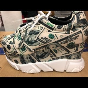Platform sneakers with money etchings.